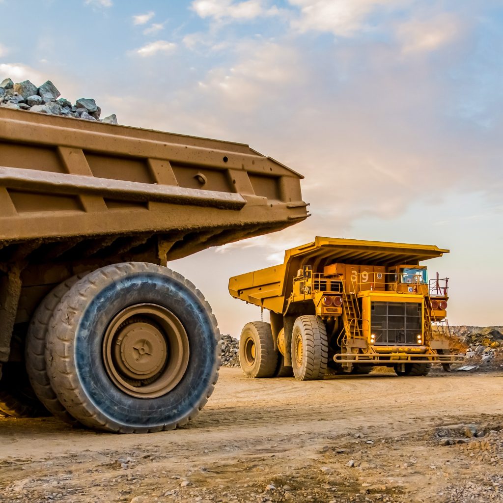 Machinery and dumping trucks outside a coal mining site